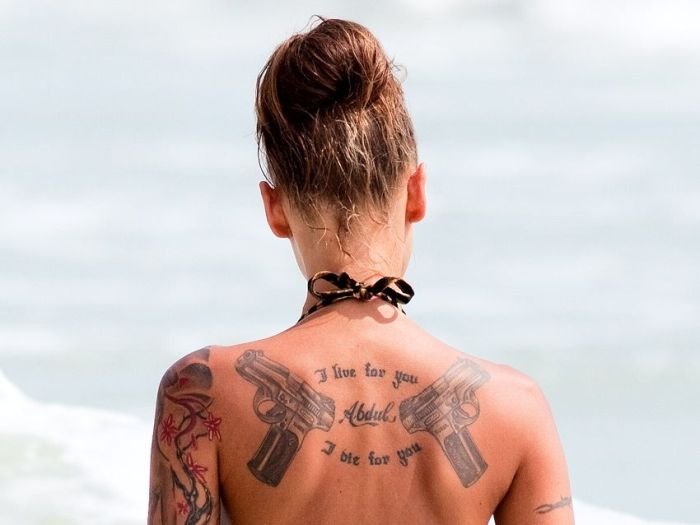 tattoo girl on the beach in the sea