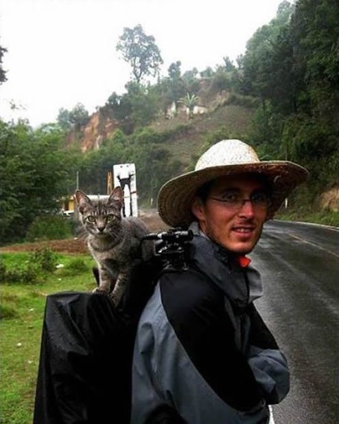 guy traveling with a cat