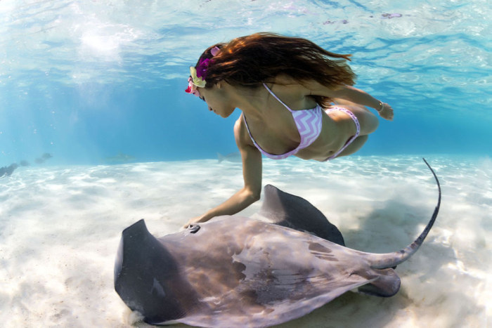 Mermaid and the stingray underwater photography by Christian Coulombe