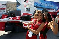 Motorsport models: Girls Pose In Front Of Dummy Of A Racing Car Instanbul 2006-08-23