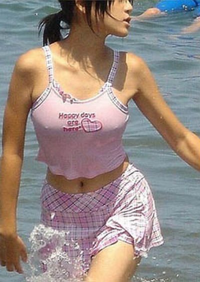 asian girl wearing pink clothes in the sea