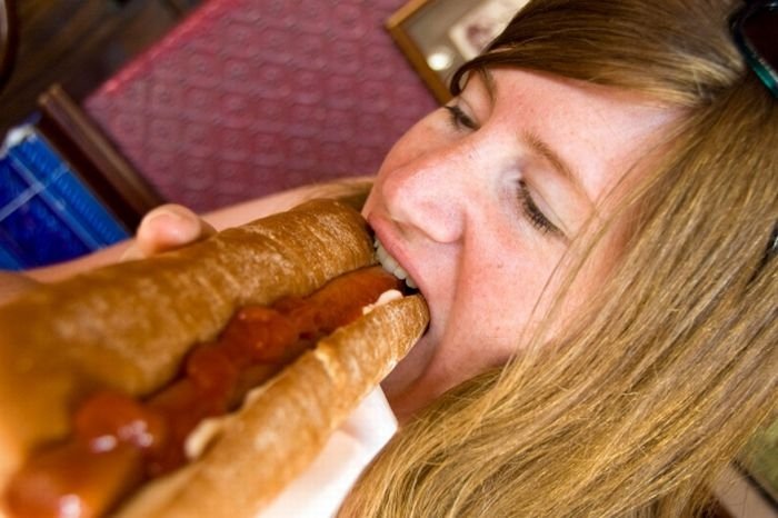 girl eating hot dog