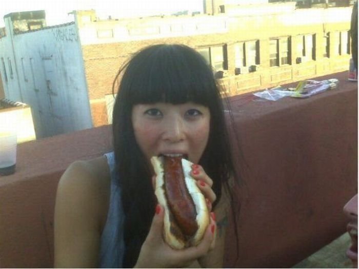 girl eating hot dog