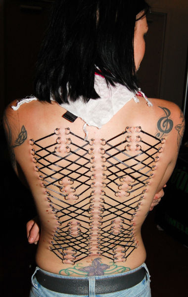 girl with a corset piercing and extreme body modifications