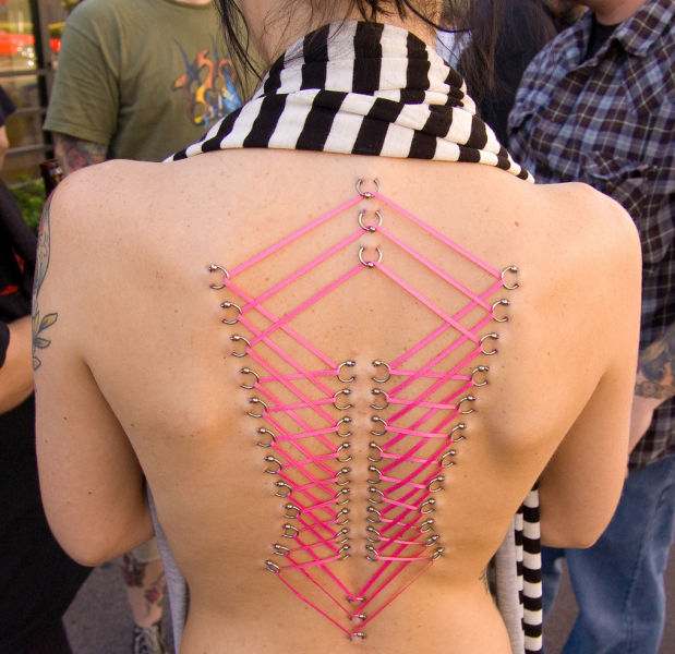 girl with a corset piercing and extreme body modifications