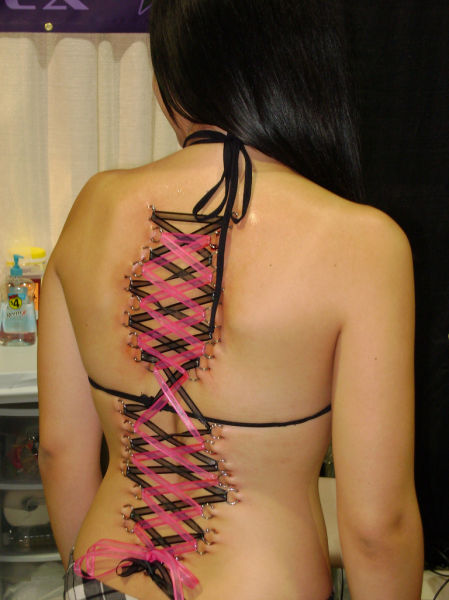 girl with a corset piercing and extreme body modifications