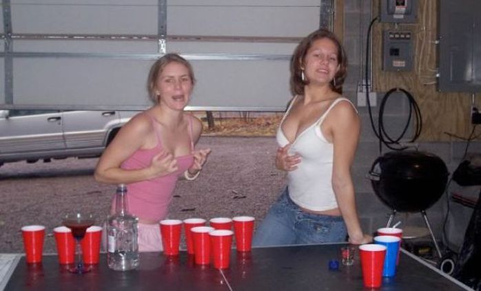 young girls playing beer pong