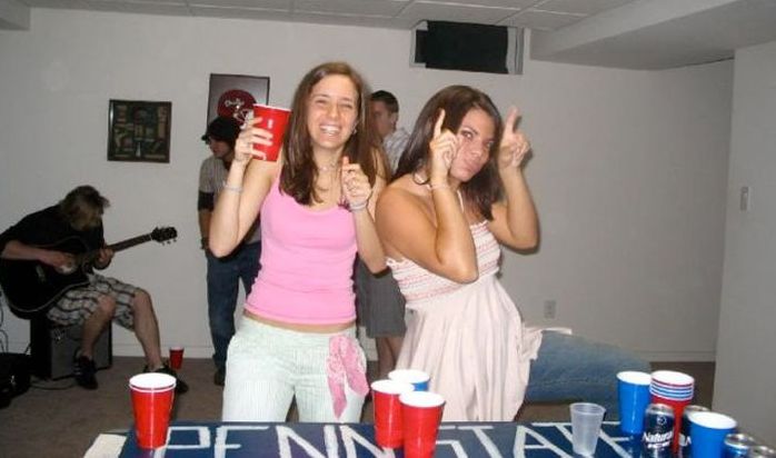 young girls playing beer pong
