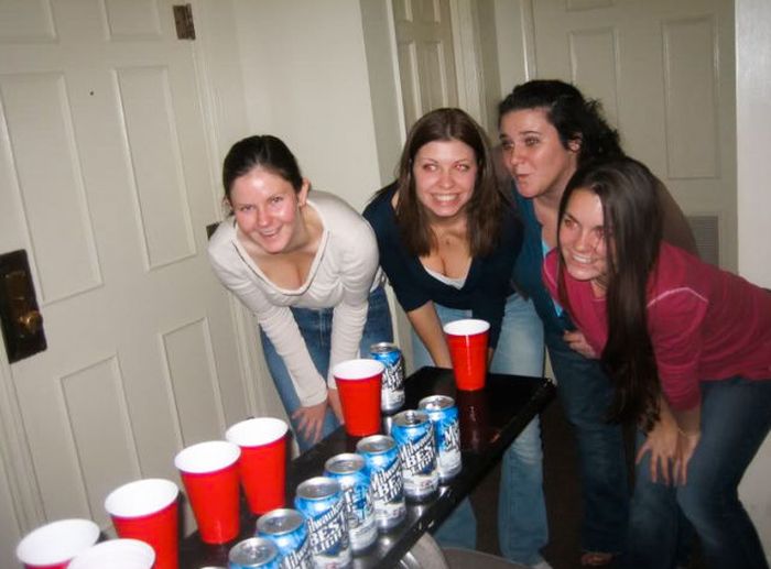 young girls playing beer pong