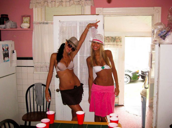 young girls playing beer pong