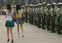 People & Humanity: two girls behind soldiers