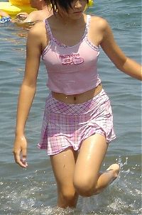 People & Humanity: asian girl wearing pink clothes in the sea