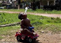 People & Humanity: 2-year-old boy smokes, Indonesia