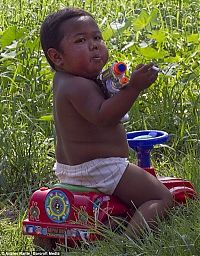 People & Humanity: 2-year-old boy smokes, Indonesia