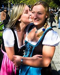 People & Humanity: Oktoberfest girls kissing, Munich, Bavaria, Germany