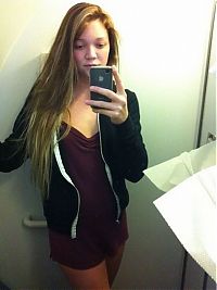 People & Humanity: young teen girl taking pictures in a mirror with iphone