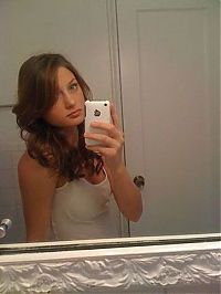 People & Humanity: young teen girl taking pictures in a mirror with iphone