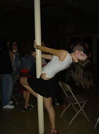 People & Humanity: young teen college girls performing a pole dancing solo