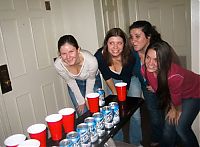 People & Humanity: young girls playing beer pong