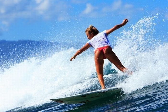 young surfing girl