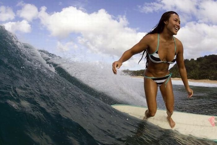 young surfing girl