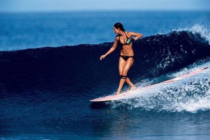 young surfing girl