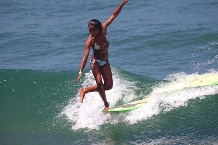 young surfing girl