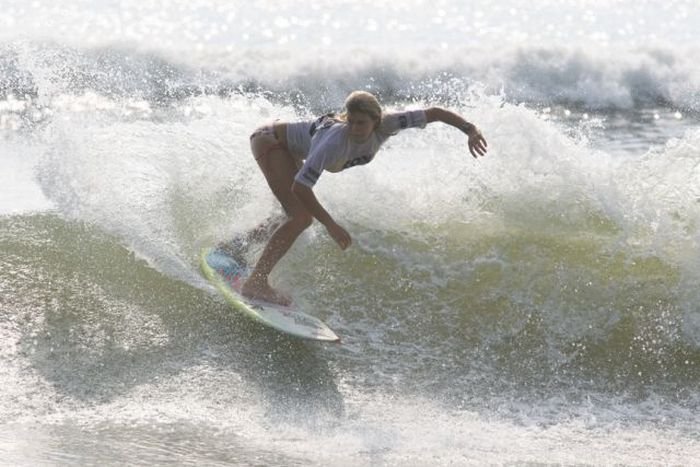 young surfing girl