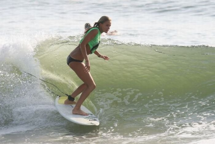 young surfing girl