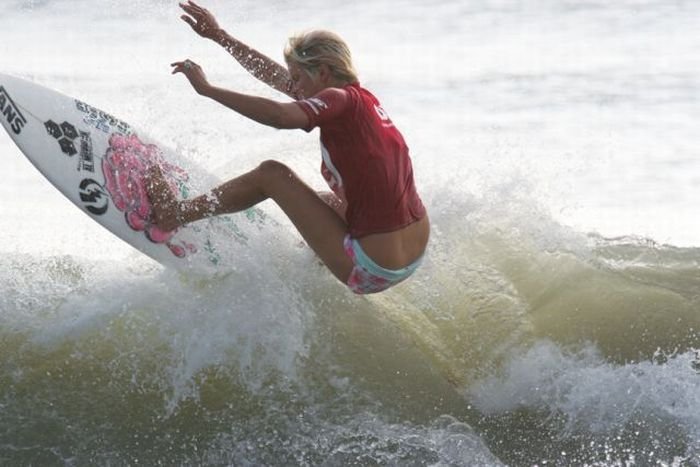 young surfing girl