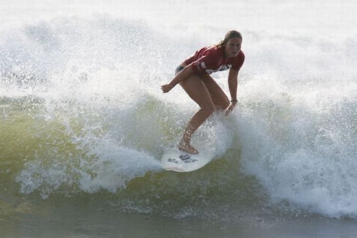 young surfing girl