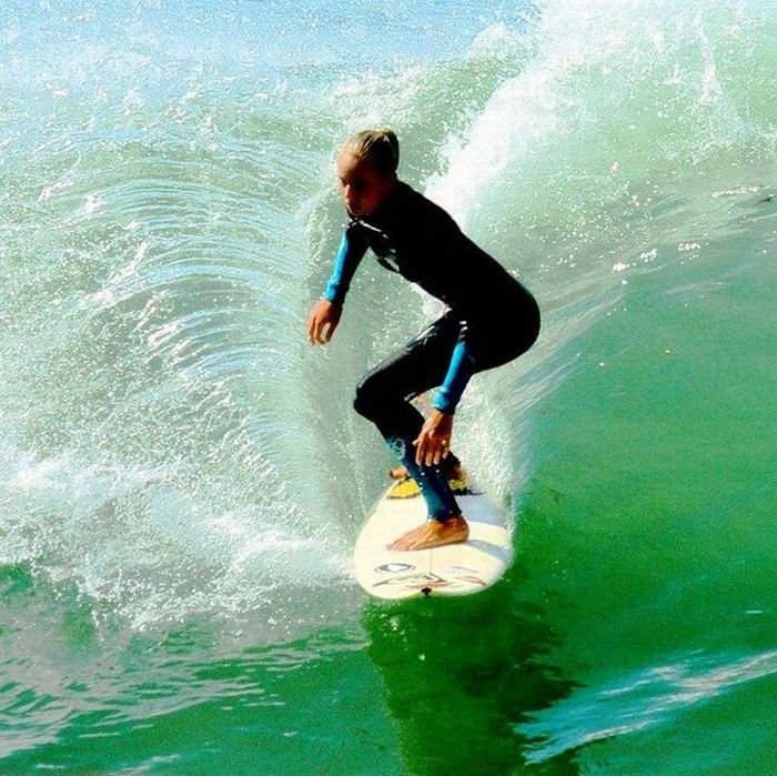 young surfing girl