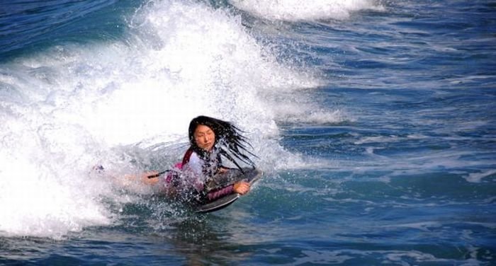 young surfing girl