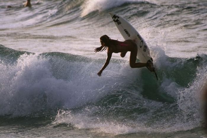 young surfing girl