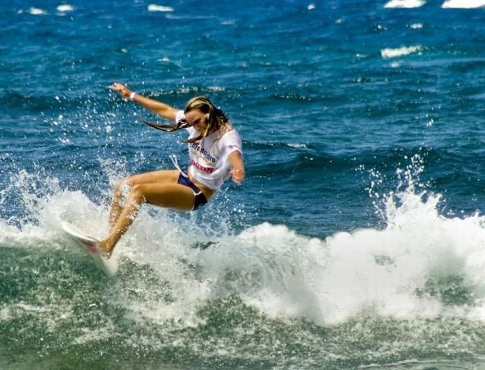 young surfing girl