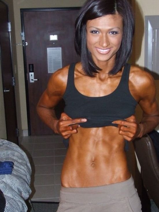 strong fitness bodybuilding girl with abdominal six-pack belly muscles