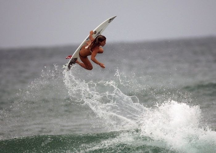 young surfing girl