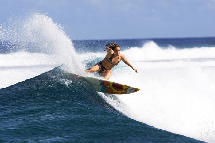 young surfing girl