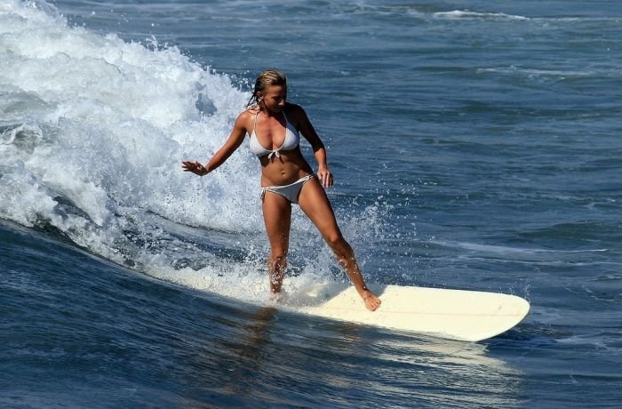 young surfing girl