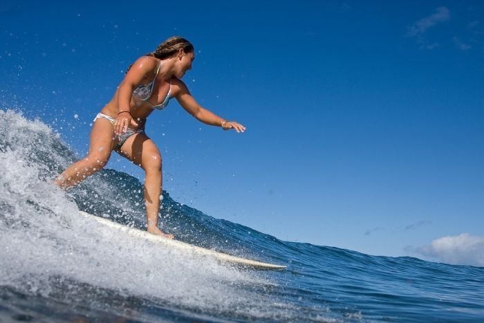 young surfing girl