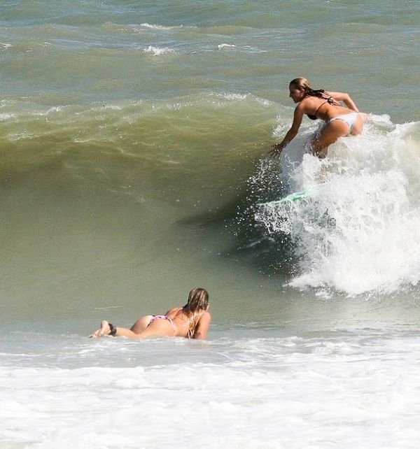 young surfing girl