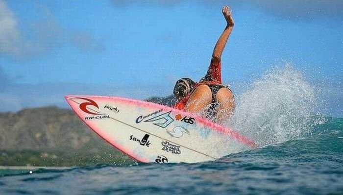 young surfing girl