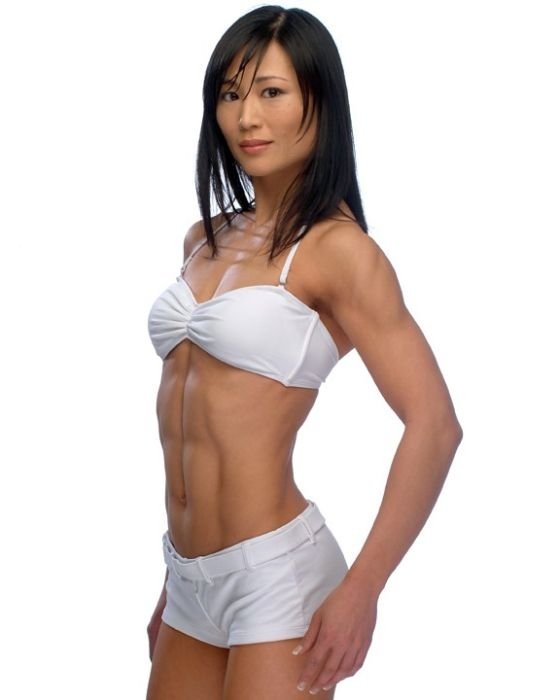 strong fitness bodybuilding girl with abdominal six-pack belly muscles