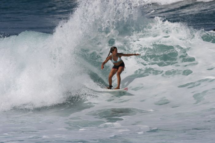 young surfing girl