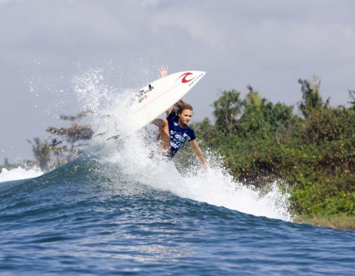 young surfing girl