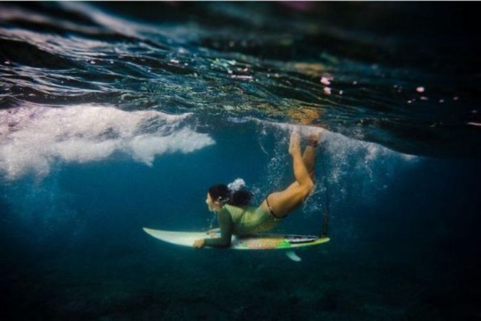 young surfing girl