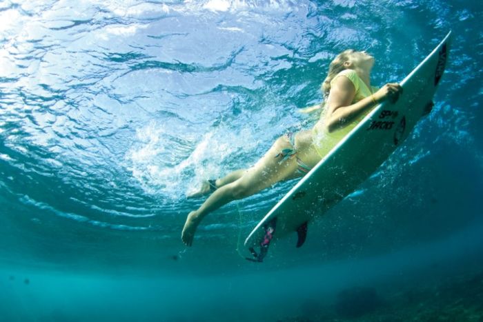 young surfing girl