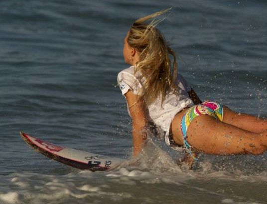 young surfing girl