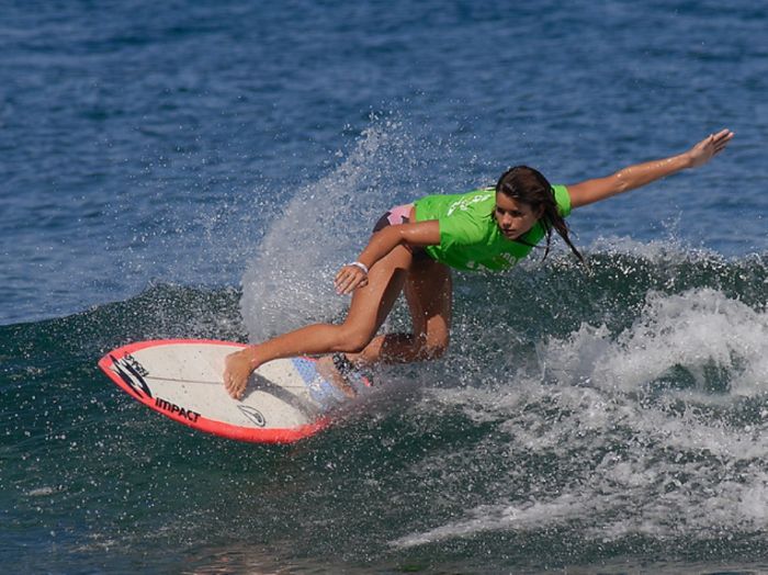 young surfing girl