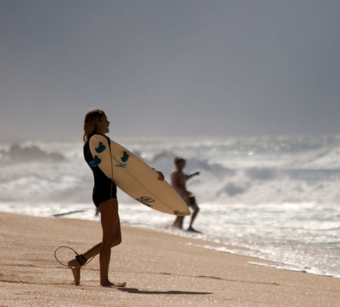 young surfing girl